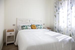 Łóżko lub łóżka w pokoju w obiekcie Apartamentos La Quinta