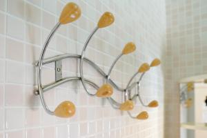 a metal towel rack with mushrooms on a bathroom wall at B&B Sara in Santa Maria al Bagno