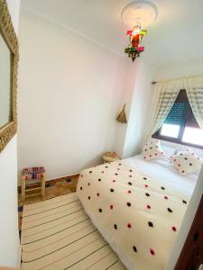 a bedroom with a bed with white sheets and a window at DAR ADIL KASBAH in Tangier