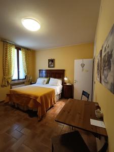 - une chambre avec un grand lit et une table dans l'établissement Agriturismo Villa Greggio, à Casalserugo