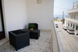 a balcony with a couch and a table on a street at B&B Sara in Santa Maria al Bagno
