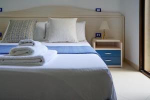 a bedroom with a bed with towels on it at B&B Sara in Santa Maria al Bagno
