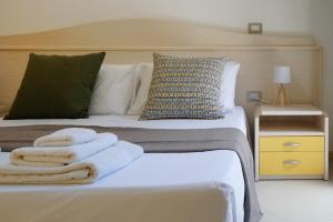 a bedroom with a bed with towels on it at B&B Sara in Santa Maria al Bagno