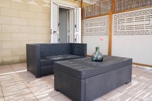 a patio with a bench and a vase on it at B&B Sara in Santa Maria al Bagno