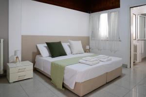 a white bedroom with a large bed and a window at B&B Sara in Santa Maria al Bagno