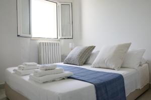 a bed with towels on it with a window at B&B Sara in Santa Maria al Bagno