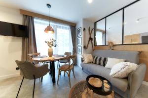 a living room with a couch and a table at Tatra Square Apartments in Zakopane