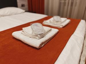 two towels are sitting on top of a bed at Apart-Hotel Shell in Tbilisi City