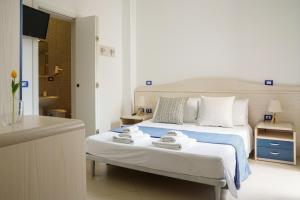 a bedroom with a bed with two towels on it at B&B Sara in Santa Maria al Bagno