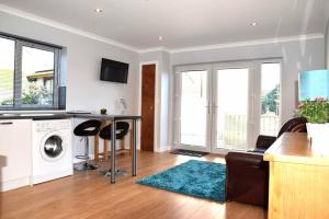 a living room with a washer and dryer at Rammal Lodge - Entire home, self catering apartment in Inverness in Inverness