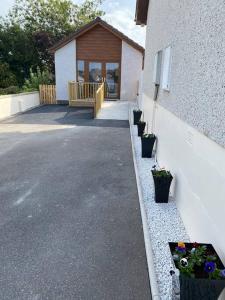 a building with potted plants on the side of it at Rammal Lodge - Entire home, self catering apartment in Inverness in Inverness