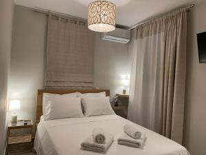 a bedroom with a bed with towels on it at Elaionas Apartments 2 in Riglia