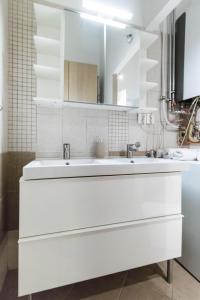 un baño blanco con un gran lavabo blanco en Leda's Apartment Next to the Danube and Fashion Street en Budapest