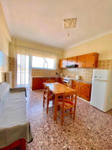 a kitchen with a table and a kitchen with a bed at Dimitris apartment in Diakopto