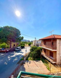 a view of a street with a building and a parking lot at Dimitris apartment in Diakopto