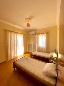 a bedroom with two beds in a room at Dimitris apartment in Diakopto