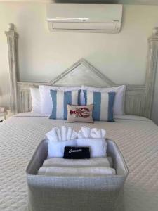 a bedroom with a bed with towels on it at Allen Harbor Rentals in Harwich Port