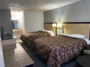 Postel nebo postele na pokoji v ubytování Executive Inn