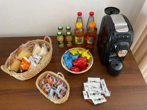 a table with three baskets of food and a coffee maker at B&B Antica Locanda San Ciriaco in Buonvicino