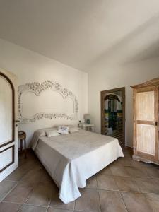 a bedroom with a large bed with a white headboard at Villa Smeralda in Olbia