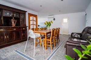 a dining room with a wooden table and chairs at Hotelik Maria in Szczytno