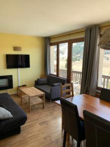 a living room with a couch and a table at Gréolières les neiges in Gréolières