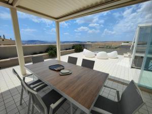 a table and chairs on a patio with a view at Golden Suite Apartments in Matera