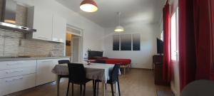 a kitchen and dining room with a table and chairs at Casa vacanze Lucilla in Cecina +7 photos