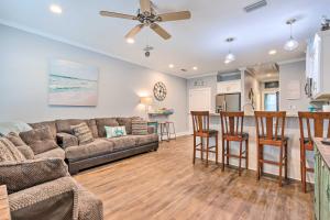 a living room with a couch and a kitchen at Dauphin Island Retreat 2 Blocks to Beach! in Dauphin Island