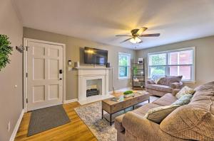 a living room with a couch and a fireplace at Charming Charleston Home with Yard and Fire Pit! in Charleston