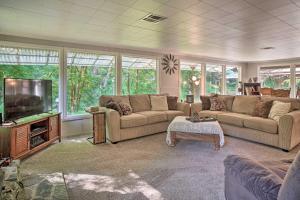 a living room with couches and a flat screen tv at Outdoor Adventure Tranquil Creekside Retreat in Merlin