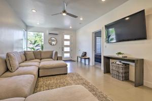 a living room with a couch and a flat screen tv at Sunny Resort Townhome and Balcony and Pool Access in St. George