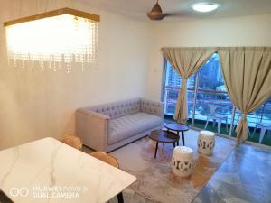 a living room with a couch and a table at PD Lagoon Resort in Port Dickson