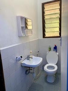 a bathroom with a toilet and a sink at Mambo & Jambo House in Mwanza