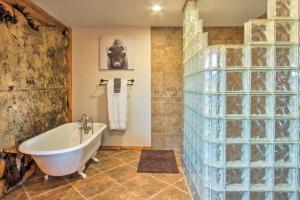 a bathroom with a tub and a glass wall at Stunning Mountain-View Ranch on 132 Acres! in Georgetown +37 photos