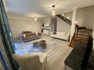 a living room with two couches and a table at Sky Villas Hisar in Trabzon