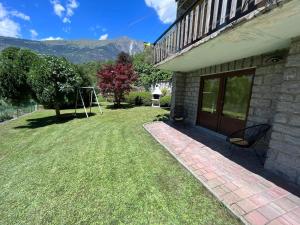 a house with a yard with a swing at casa Fedora cir 0020 in Saint Vincent