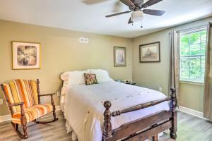 a bedroom with a bed and a fan and a chair at Secluded Chattanooga Getaway with Deck and Yard! in Chattanooga