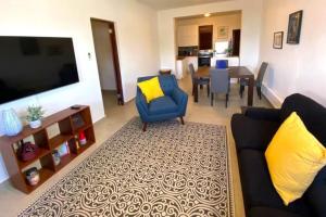 a living room with a couch and a dining room at KASA Charming Luna 2 bedroom in San Juan