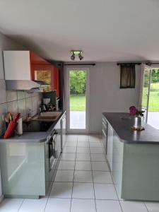 a kitchen with a sink and a counter at Le Petit Atelier in Excénevex