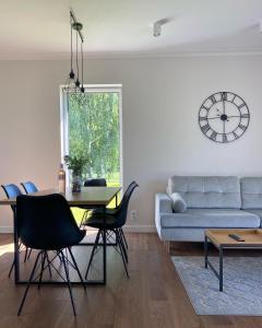 a living room with a table and a couch at Domy na polanie-Szafirek in Polanica-Zdrój