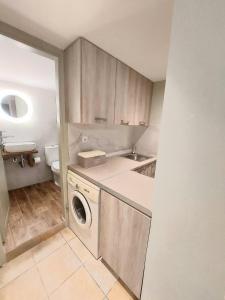 a small kitchen with a washing machine in it at Bizaniou Apartment 69 in Preveza