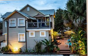 a house with a balcony and a patio at At Journey's End in Saint Augustine