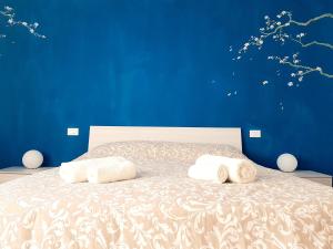 Il Mughetto - Appartamento con Terrazza Privata tesisinde bir odada yatak veya yataklar