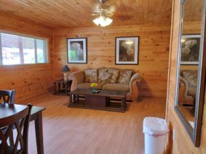 a living room with a couch and a table at Olympian Resort Motel in Diamond Point