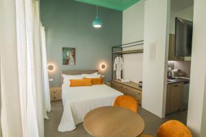 a bedroom with a bed and a table in it at Ialemos Group in Symi