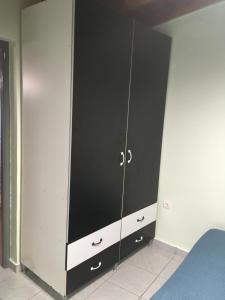 a black and white cabinet in a bedroom at Leonidas apartments 1 in Sparti