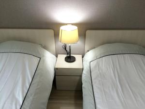 Postel nebo postele na pokoji v ubytování Busan Central Hotel