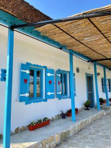 a house with blue windows and hearts on the wall at Casa cu stuf Murighiol in Murighiol