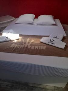 two beds with white sheets and pillows on them at NEPTUNUS in Nieuwpoort